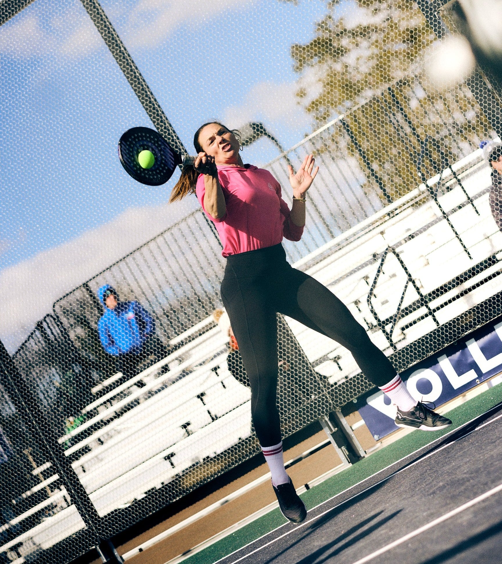 Woman jumping to hit a paddle shot